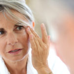 Senior woman applying anti-wrinkles cream